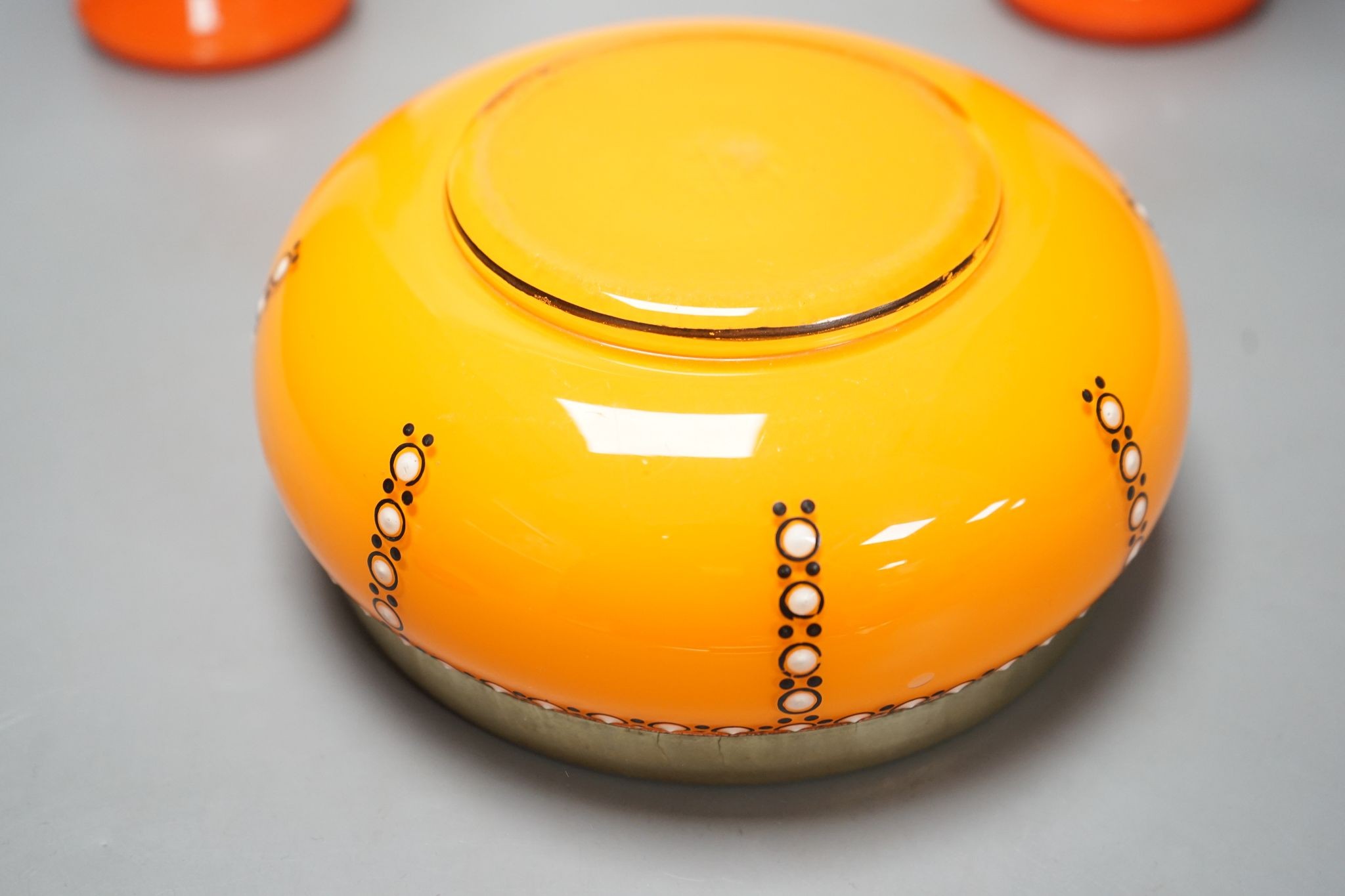 A tangerine glass bowl with silver plated mount to rim and a pair of spill vases, in the style of Michael Powdry, tallest 21cm